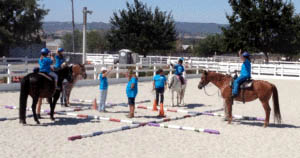 Photo courtesy One Step Closer Children learn basic riding skills from volunteers at One Step Closer in Morgan Hill.