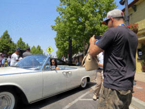 Martin Serrano takes a photo of Stephanie Vaccaro sitting in a 1963 Lincoln Continental, the same type of car that President John F. Kennedy was sitting in when he was shot in Dallas. Photo by Marty Cheek 